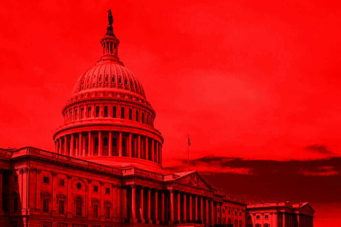 United States Capitol building under red-tinted sky.