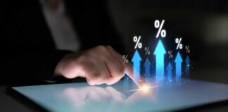 A hand touching a tablet screen with upward arrows and percentage symbols