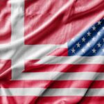 A close-up of a fabric featuring the flags of Denmark and the United States intertwined