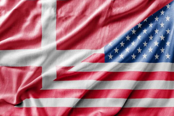 shutterstock_1362818942.jpg A close-up of a fabric featuring the flags of Denmark and the United States intertwined
