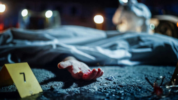 shutterstock_2230645915.jpg Crime scene with covered body and hand exposed.