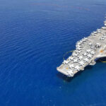 Aircraft carrier on a vast blue ocean
