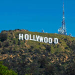 Hollywood sign on a green mountain hillside.
