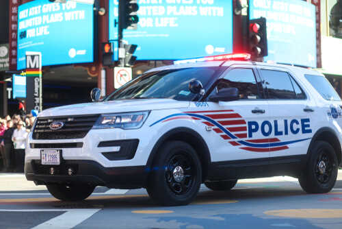 shutterstock_1027874389.jpg Police SUV with lights on in an urban environment