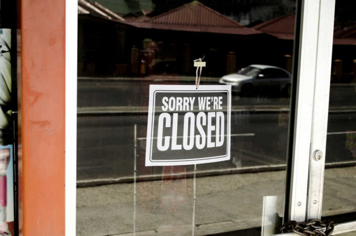 shutterstock_205488685.jpg Closed sign hanging on a glass door
