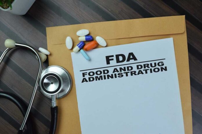 shutterstock_2260831465.jpg FDA document with pills and a stethoscope on a wooden surface