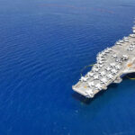 Aircraft carrier on a vast blue ocean