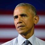 Barack Obama in front of flag.