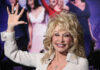 Dolly Parton waving and smiling