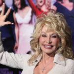 Dolly Parton waving and smiling