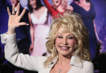 Dolly Parton waving and smiling