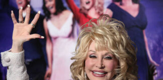 Dolly Parton waving and smiling