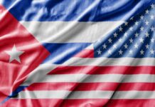 Close-up of the Cuban and American flags displayed together