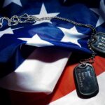 Military dog tags resting on an American flag