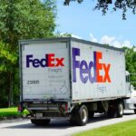 FedEx freight truck driving down a suburban street