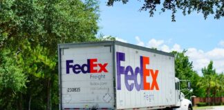 FedEx freight truck driving down a suburban street