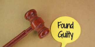 A wooden gavel next to a yellow speech bubble that says 'Found Guilty'