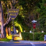 Beverly Hills street sign at sunset with a stop sign nearby