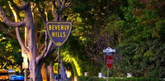 Beverly Hills street sign at sunset with a stop sign nearby