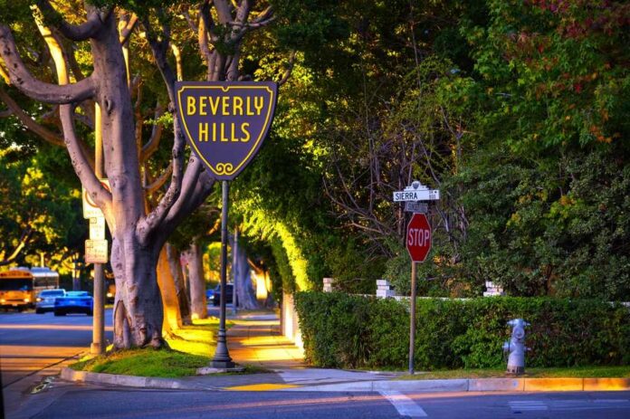 Beverly Hills street sign at sunset with a stop sign nearby