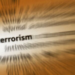 Blurred text with the word 'terrorism' in focus