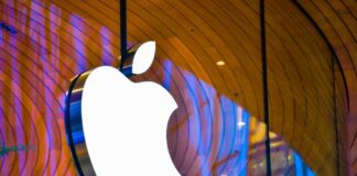Illuminated Apple logo against a wooden backdrop