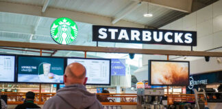 Starbucks counter in busy airport shopping area