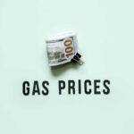 A bundle of cash next to the words 'GAS PRICES' on a light green background