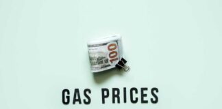 A bundle of cash next to the words 'GAS PRICES' on a light green background