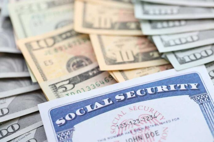 A social security card placed on top of various denominations of U.S. currency