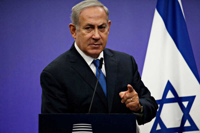 Netanyahu speaking at podium with Israeli flag.