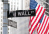 Wall Street and Broad Street signs with American flags in background
