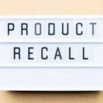 Lightbox sign with the words product recall on a beige background