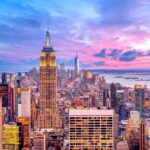 New York City skyline at dusk with skyscrapers.