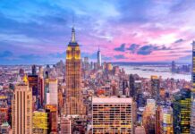 New York City skyline at dusk with skyscrapers.