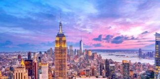 New York City skyline at dusk with skyscrapers.